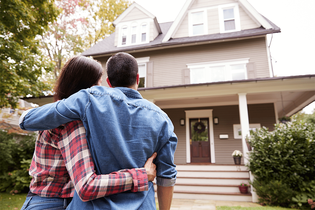 couple in front of home